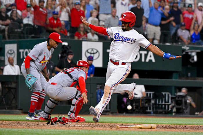 Jun 5, 2023; Arlington, Texas, USA; Texas Rangers second baseman Marcus Semien (2) crosses home plate for the game winning run against the St. Louis Cardinals during the ninth inning at Globe Life Field. Mandatory Credit: Jerome Miron-USA TODAY Sports